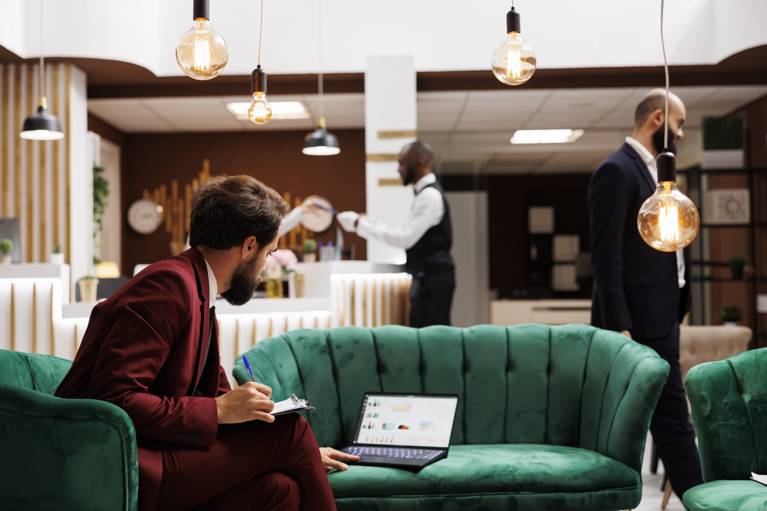 Business professional finding new ideas to forge international partnership before attending conference, hotel lounge area. CEO taking notes and preparing for important speech.